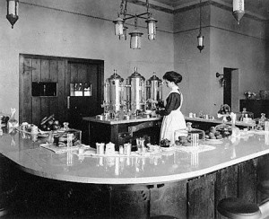 A "Harvey Girl" pouring coffee in lunchroom at Lamy, New Mexico, in early 1910's. Photograph from Northern Arizona University.