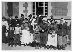 Photograph of Immigrants Outside a Building on Ellis Island by The U.S. National Archives ellis island photo