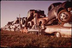 Junked Automobiles Are Piled Three Deep Along Fence by The U.S. National Archives deep state photo